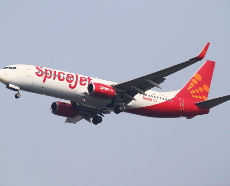 a red and white airplane in the sky