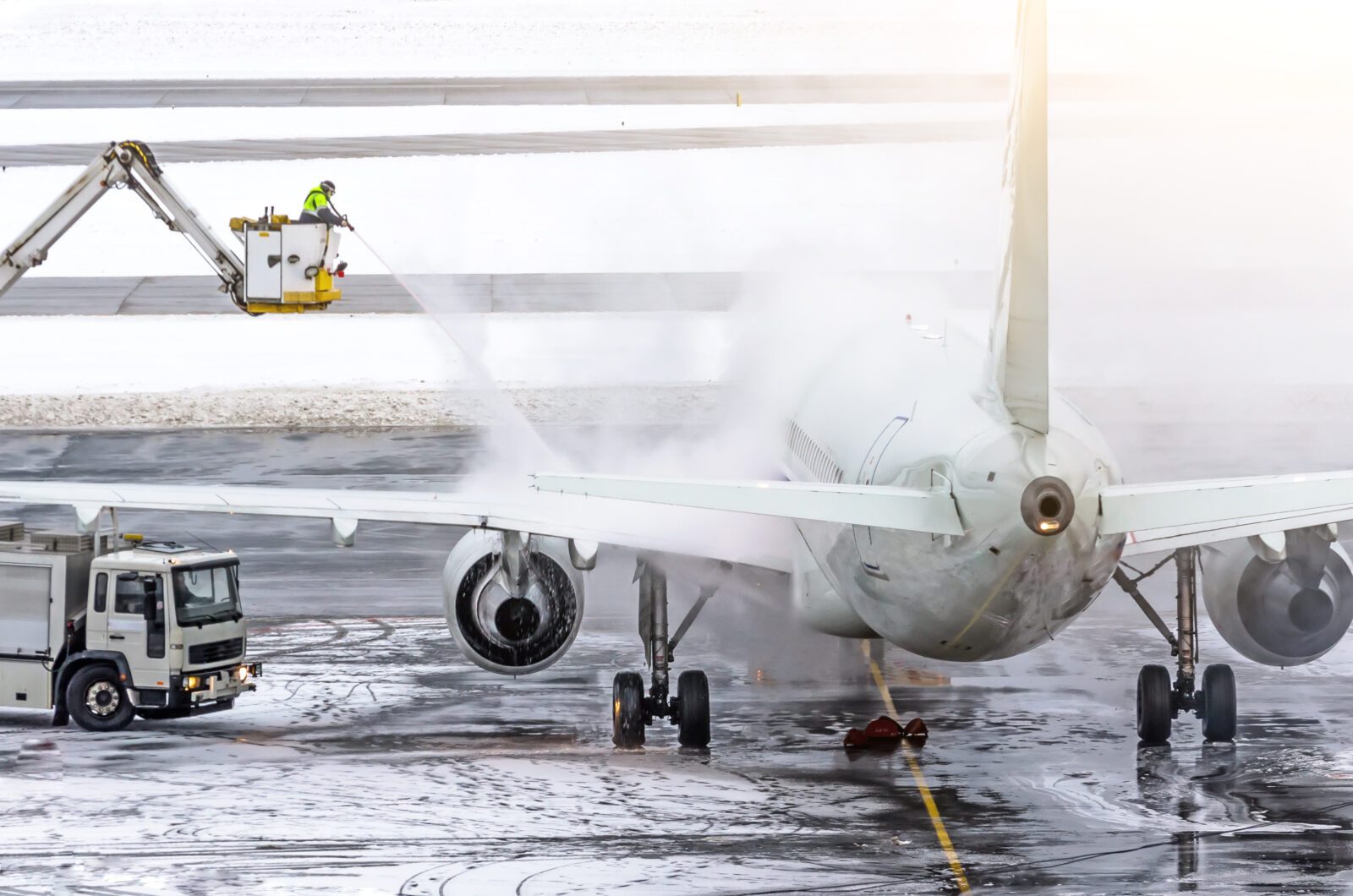 a jet plane being sprayed with water