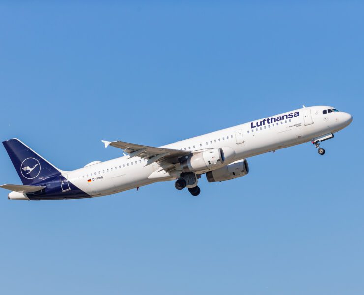 a white and blue airplane in the sky