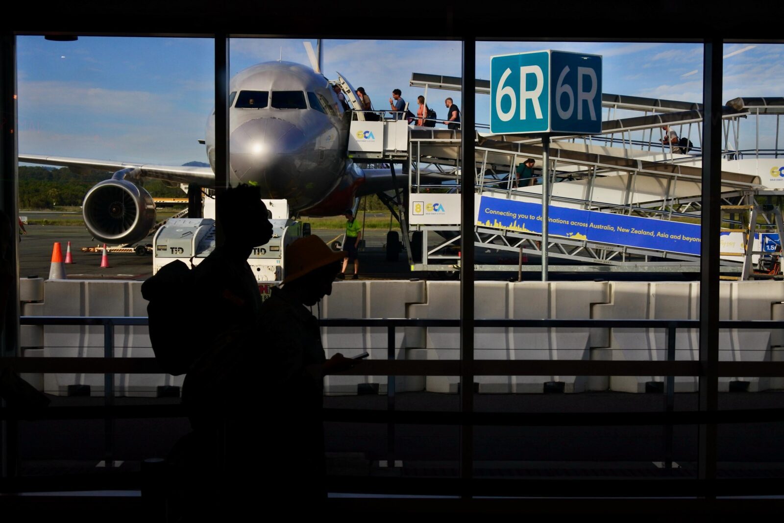 a group of people standing in front of an airplane