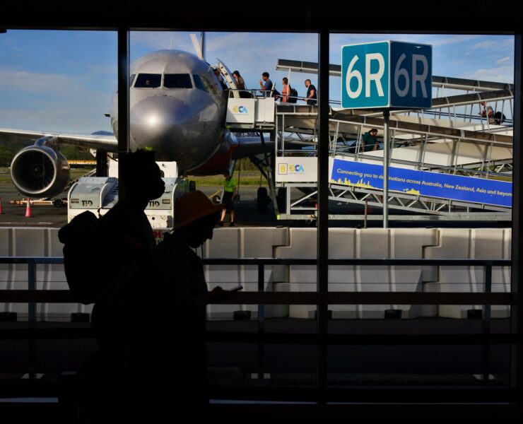 a group of people standing in front of an airplane