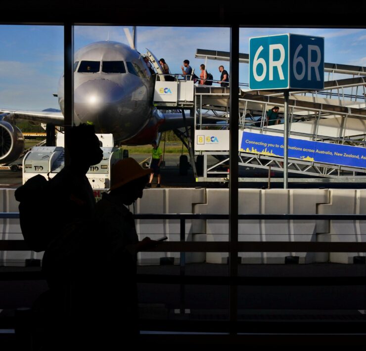 a group of people standing in front of an airplane