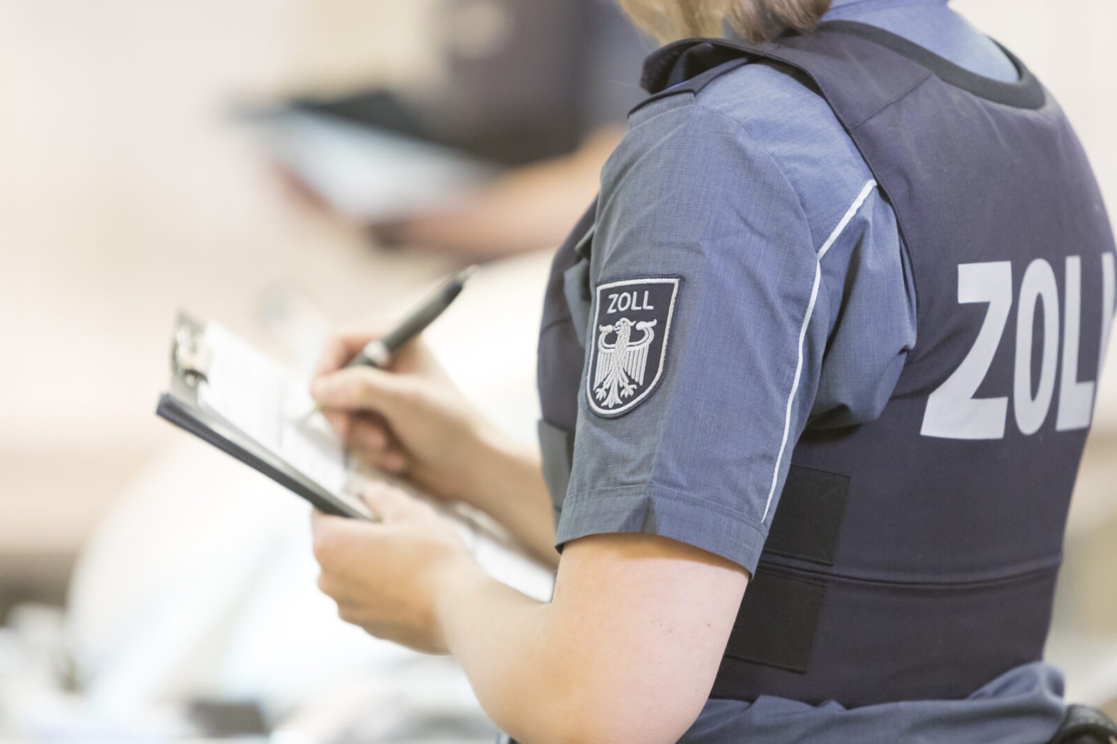 a person in uniform writing on a clipboard