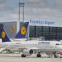 a white airplane with blue tail and yellow logo