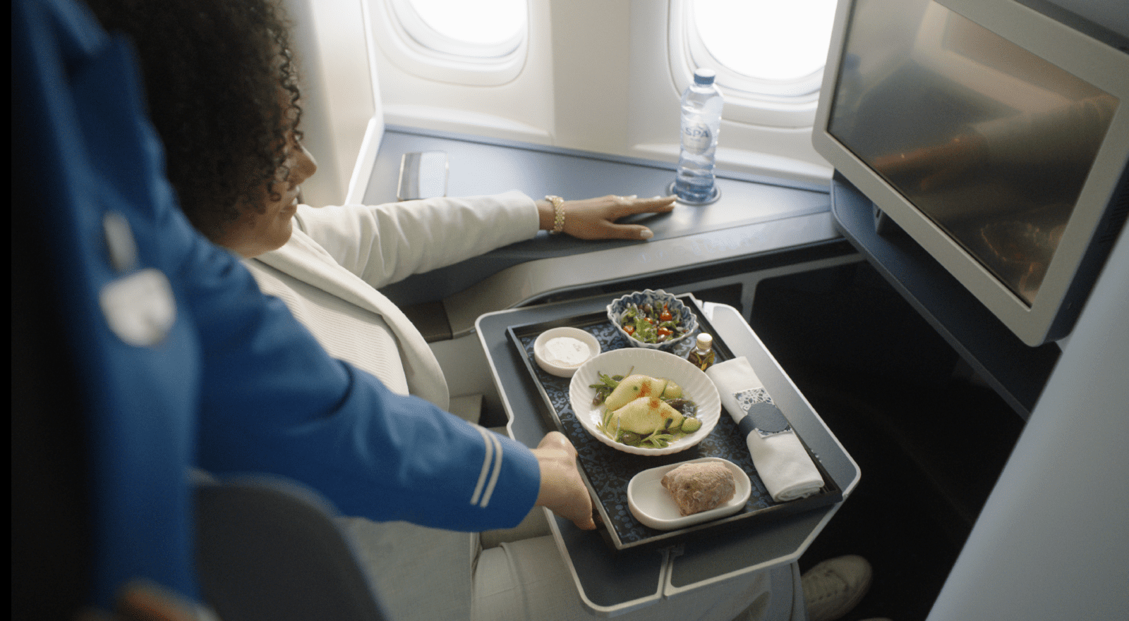 a woman holding a tray of food