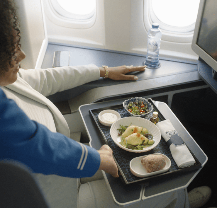 a woman holding a tray of food