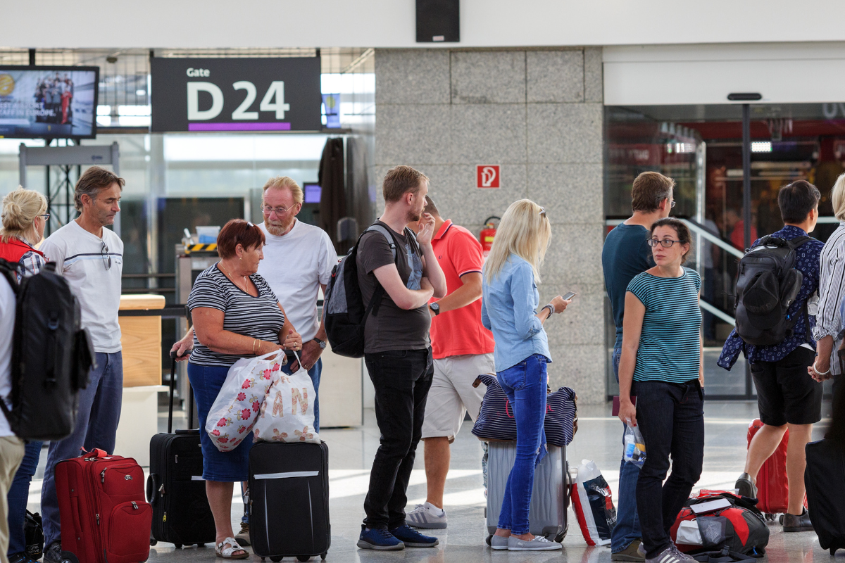 a group of people standing in a terminal