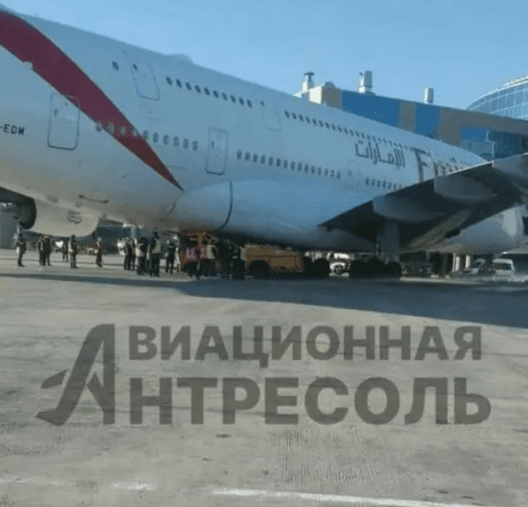 a large white airplane with red stripes