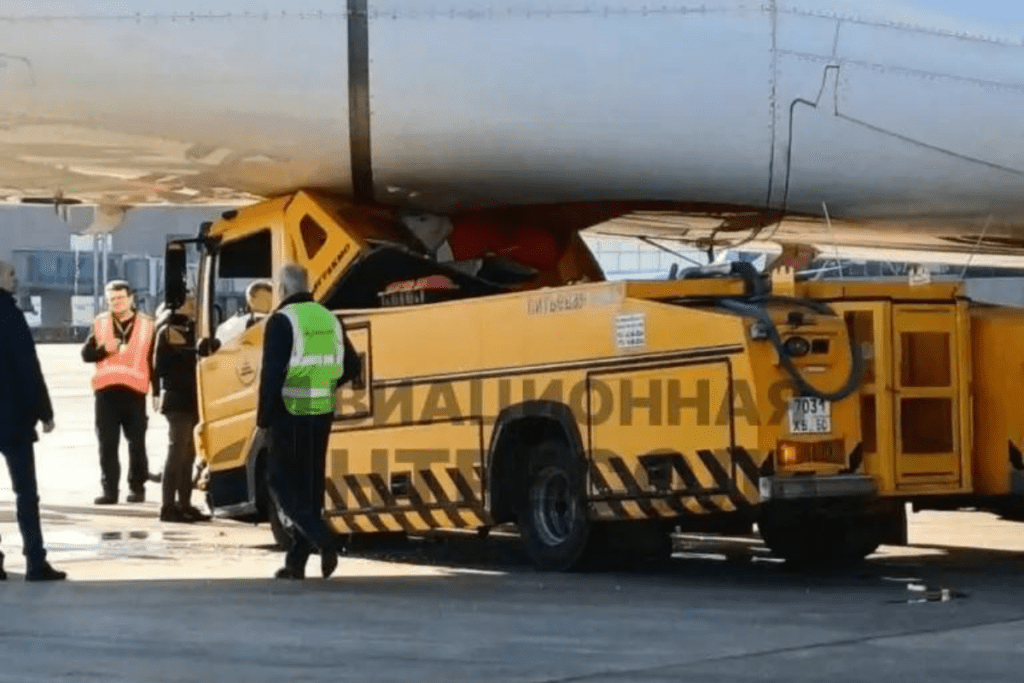 a yellow truck with a large white object on the back