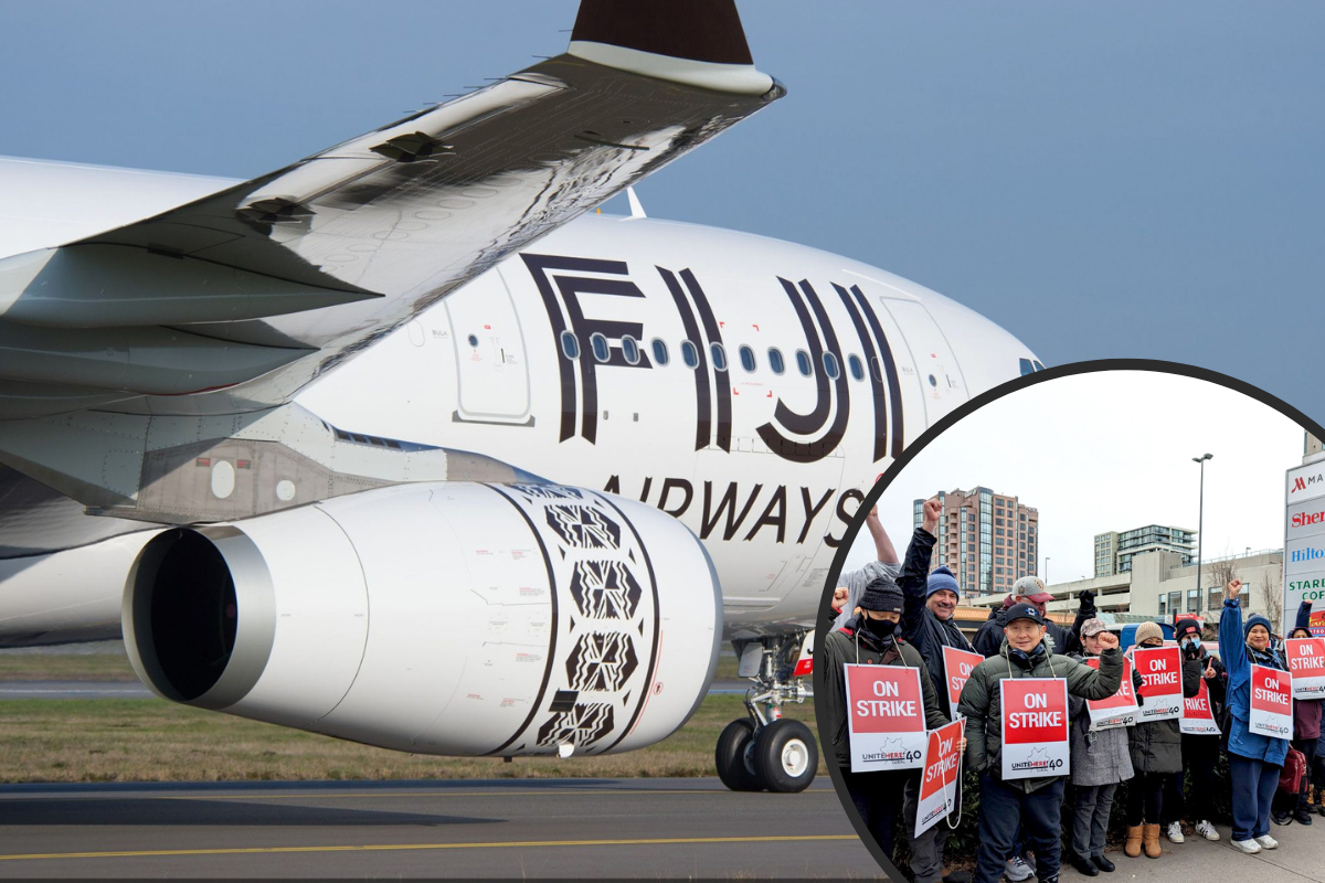 a group of people holding signs in front of an airplane