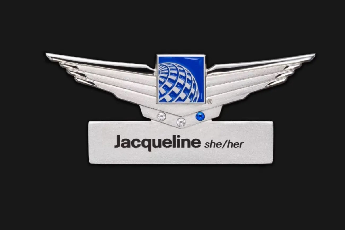 a silver badge with a blue square and a blue square with a blue square and black text