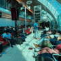 a group of people sitting in chairs in a terminal