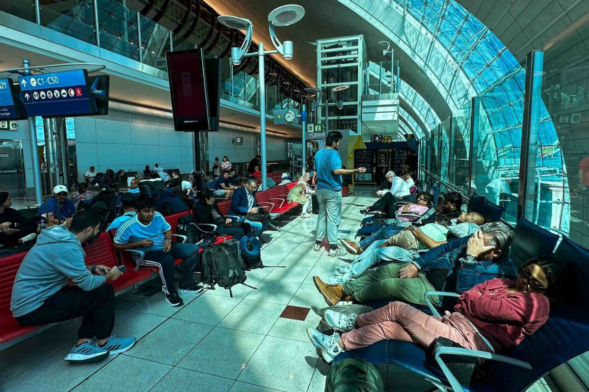 a group of people sitting in chairs in a terminal