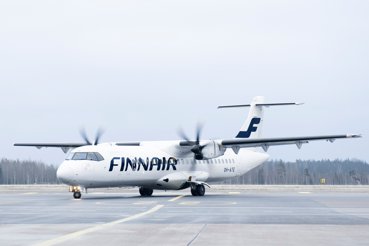 a white airplane on a runway