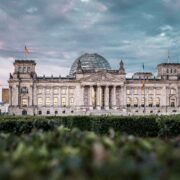 a large building with a dome and a dome with Reichstag building in the background