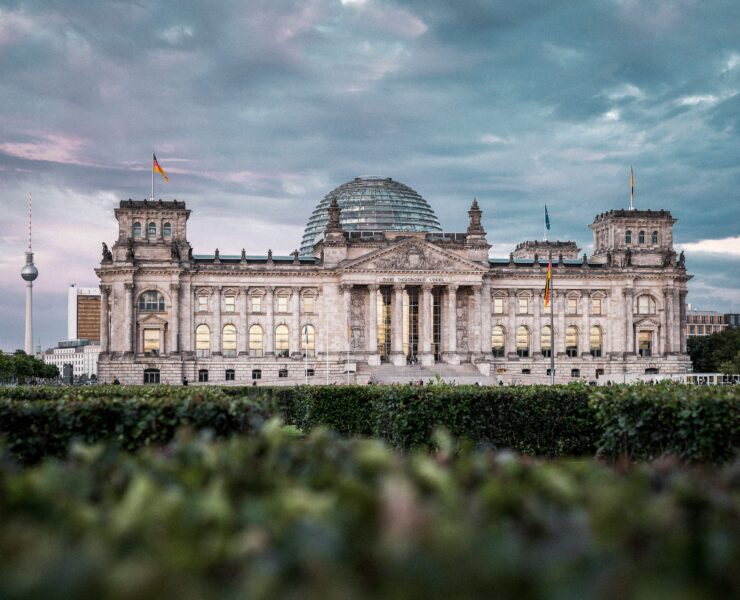 a large building with a dome and a dome with Reichstag building in the background