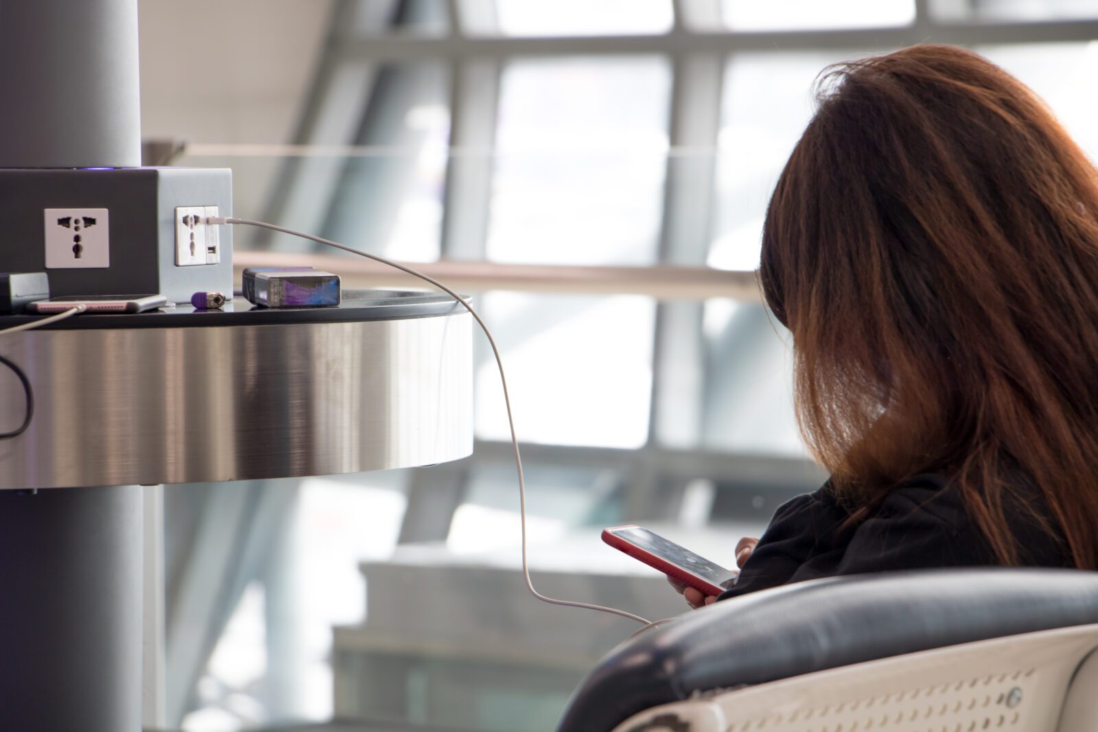 a woman sitting in a chair with a phone in her hand