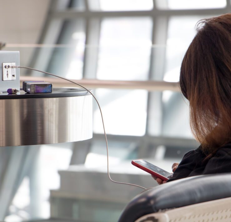 a woman sitting in a chair with a phone in her hand