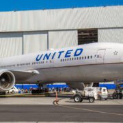 a large airplane parked in front of a building