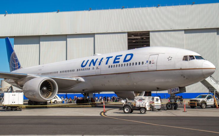 a large airplane parked in front of a building