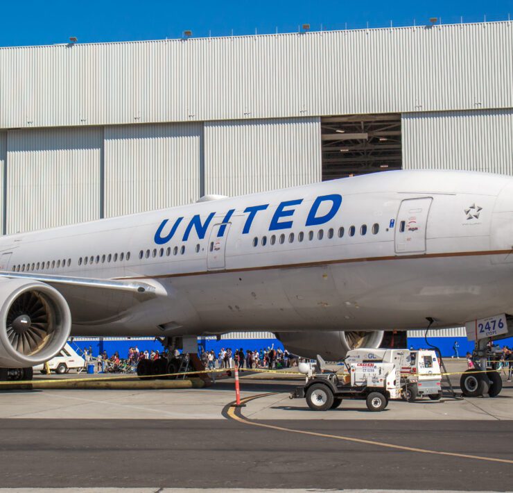 a large airplane parked in front of a building