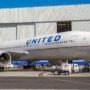 a large airplane parked in front of a building