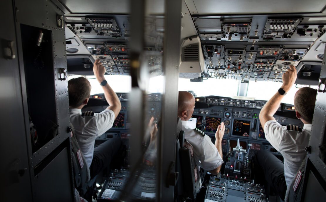 a group of men in a cockpit