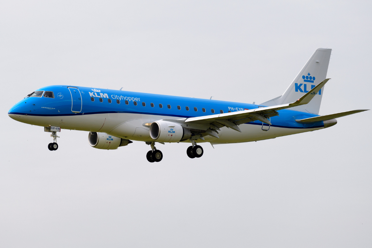 a blue and white airplane in the sky