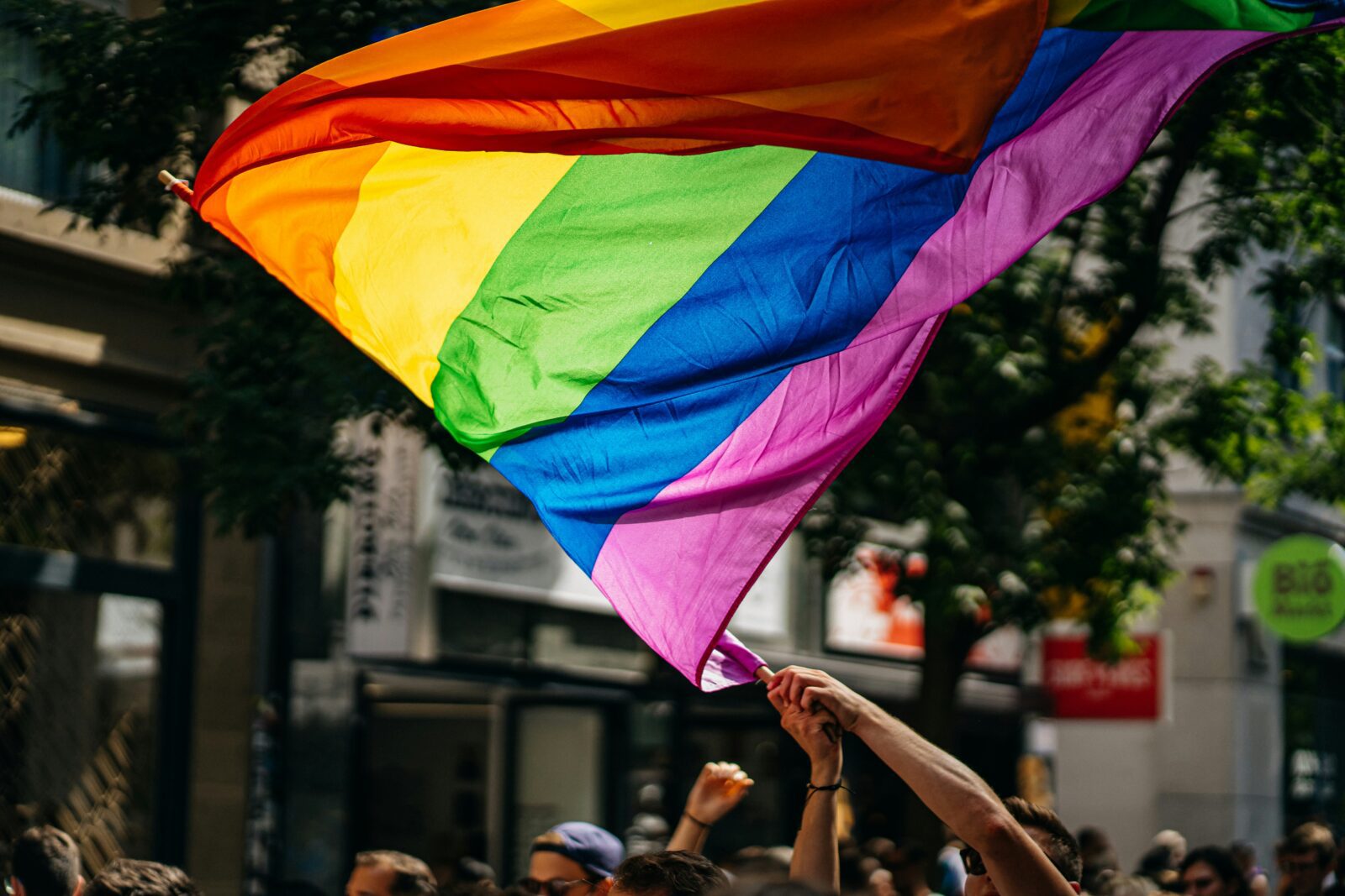 a group of people holding up a rainbow flag