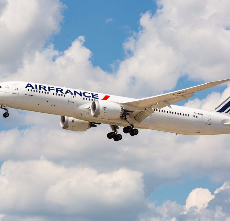 a white airplane flying in the sky