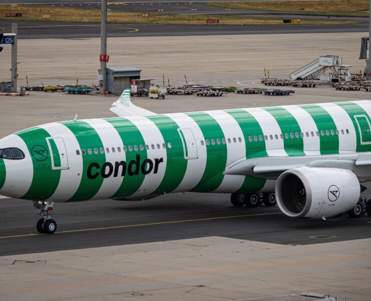 a green and white airplane on a runway