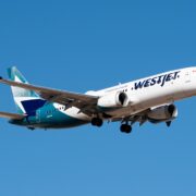 a white and blue airplane in the sky