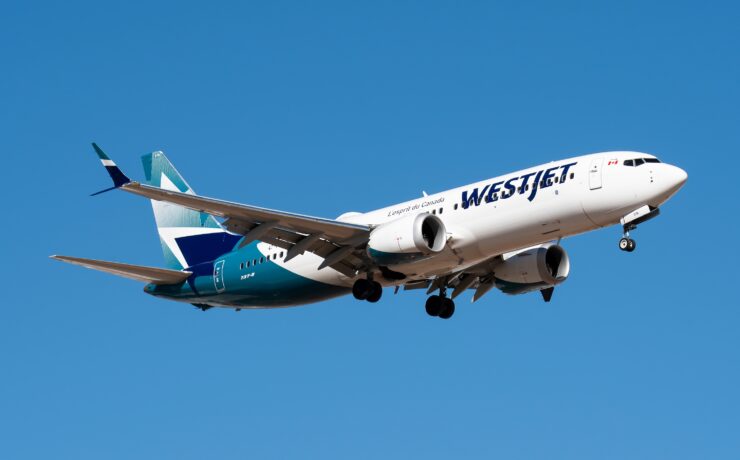 a white and blue airplane in the sky