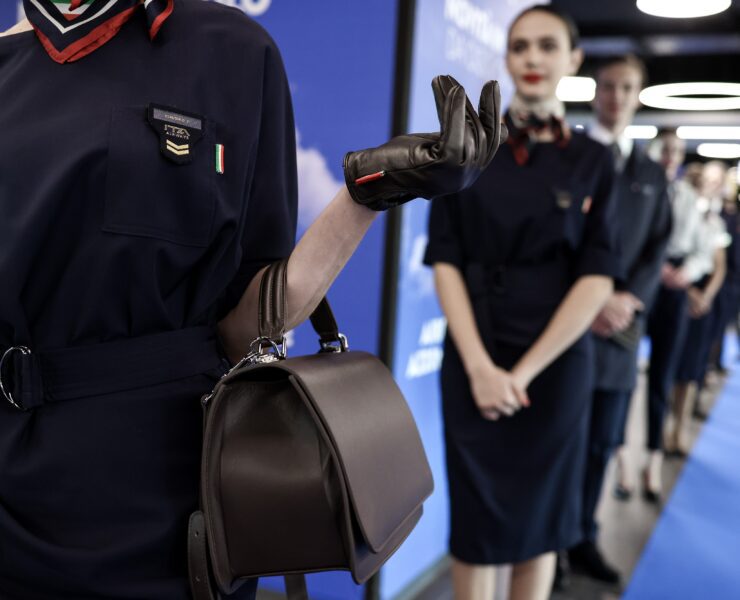 a woman wearing a leather glove and a handbag