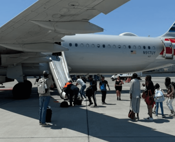 people standing next to an airplane