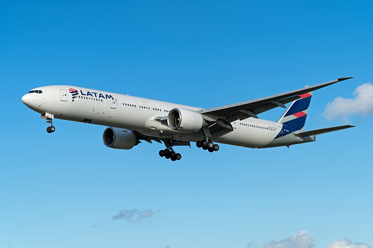 a large white airplane flying in the sky