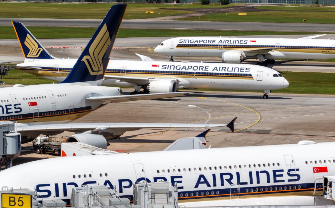 a group of airplanes on a runway