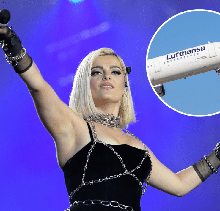 a woman wearing chains and holding a microphone