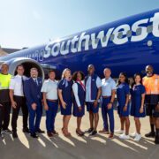 a group of people standing in front of a plane