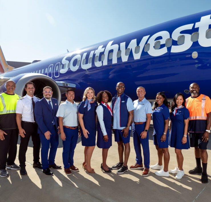 a group of people standing in front of a plane