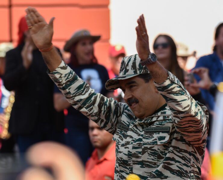 a man in a military uniform with his hands up