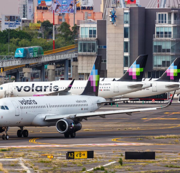 a group of airplanes parked on a runway