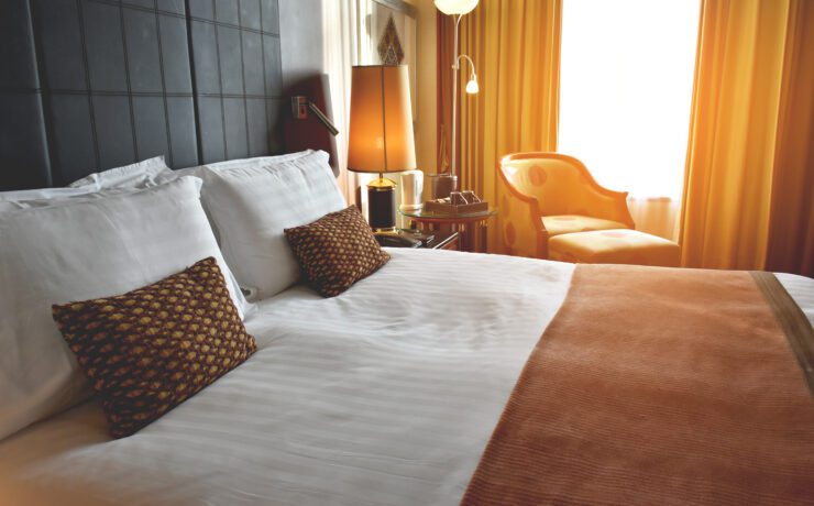 a bed with pillows and a lamp in a room