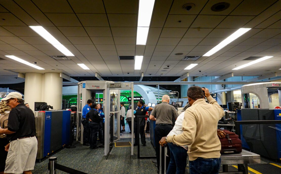 people standing in a line at an airport