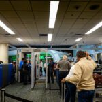 people standing in a line at an airport