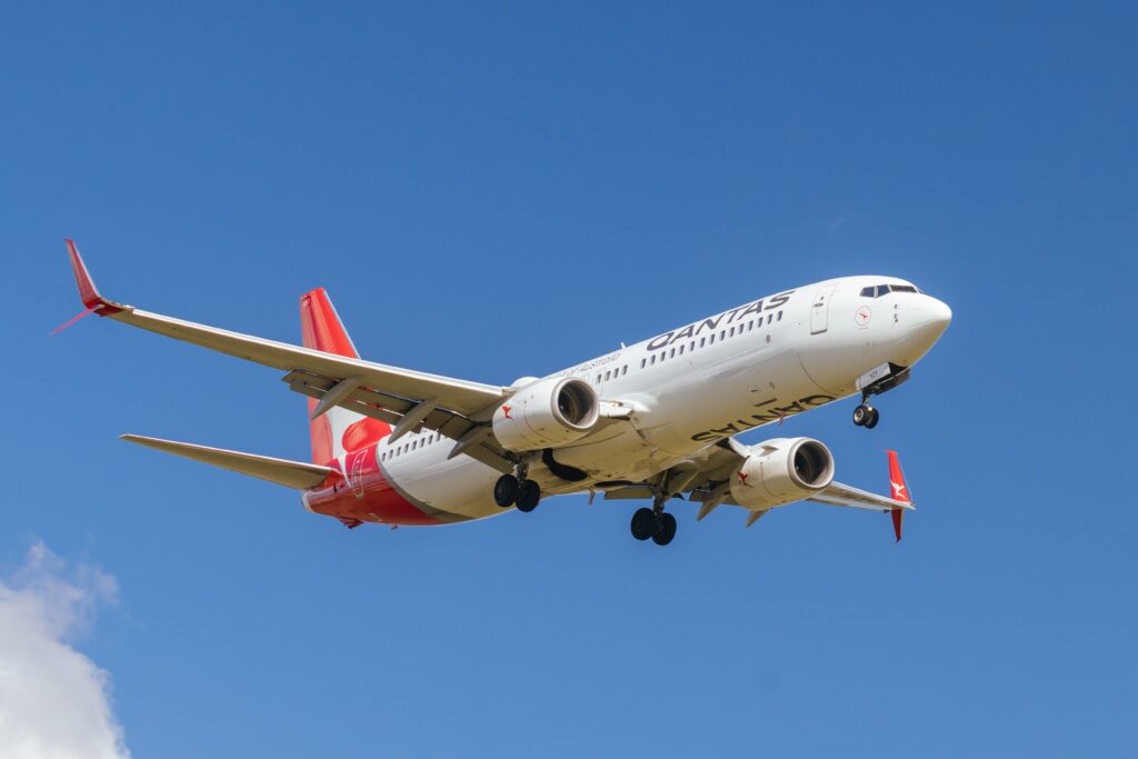 a white and red airplane in the sky