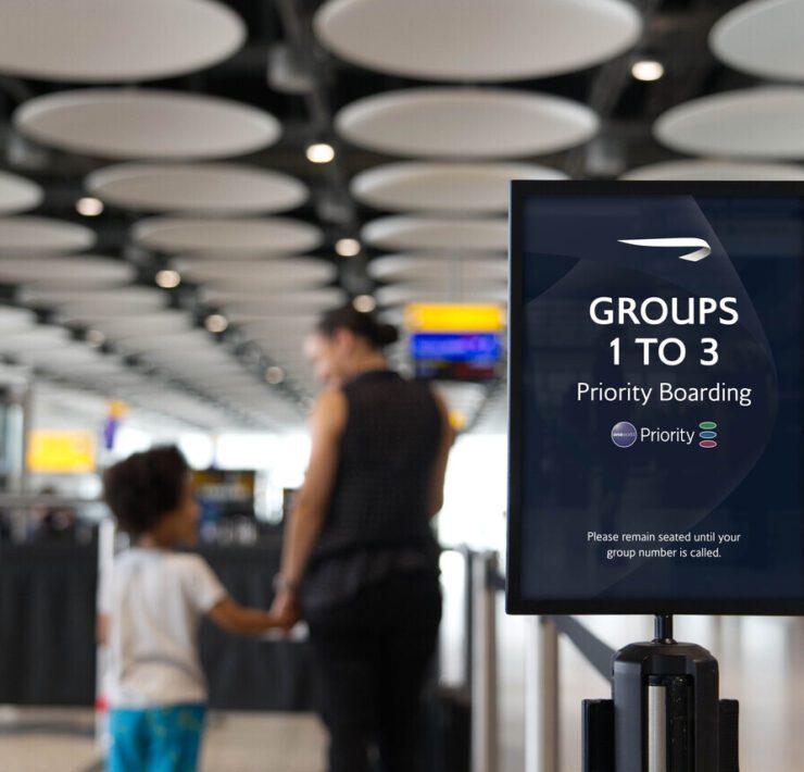 a sign in front of a group of people