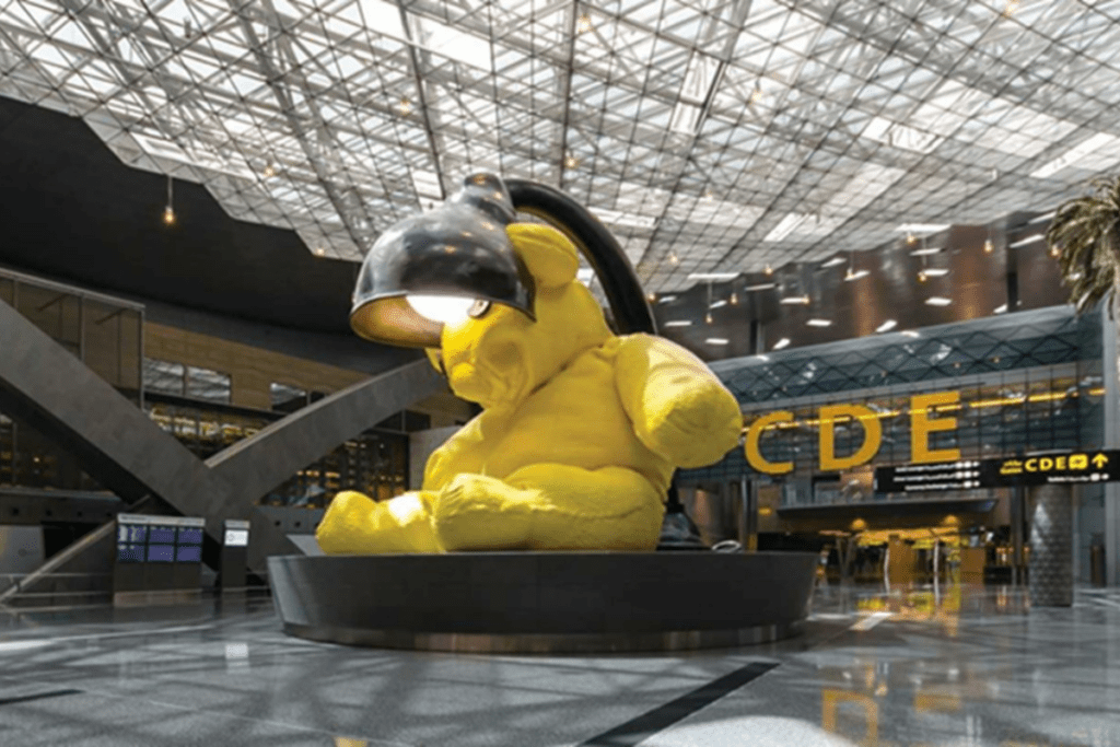 a yellow stuffed bear statue in a building