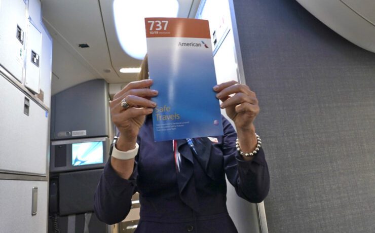 a woman holding a booklet in front of her face