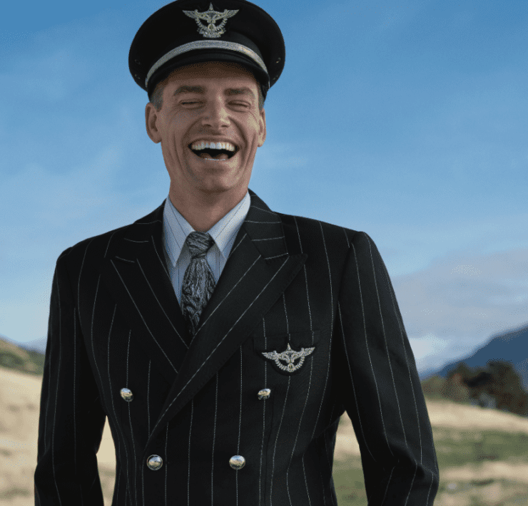 a man in a suit and hat laughing